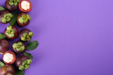 Photo of Fresh ripe mangosteen fruits with green leaves on violet background, flat lay. Space for text