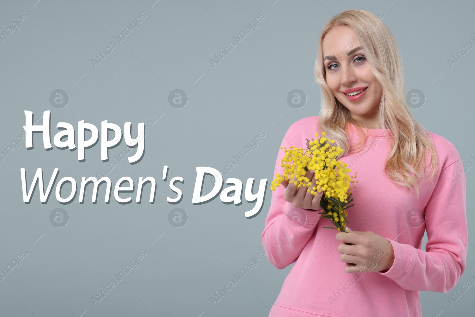Image of Happy Women's Day - March 8. Attractive lady with mimosa flowers on grey background
