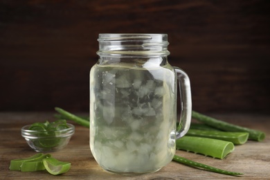 Photo of Fresh aloe drink in mason jar on wooden table