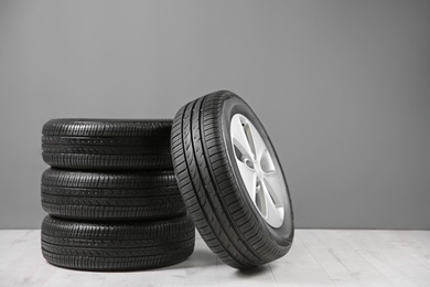Photo of Car tires near gray wall