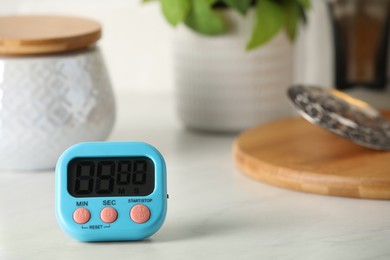 Photo of Kitchen timer on white table. Space for text