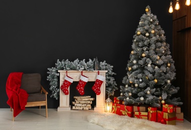 Stylish Christmas interior with decorated fir tree and fireplace