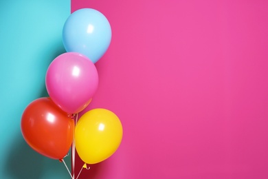 Bright air balloons for birthday party on color background