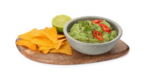 Photo of Bowl of delicious guacamole, lime and nachos chips isolated on white
