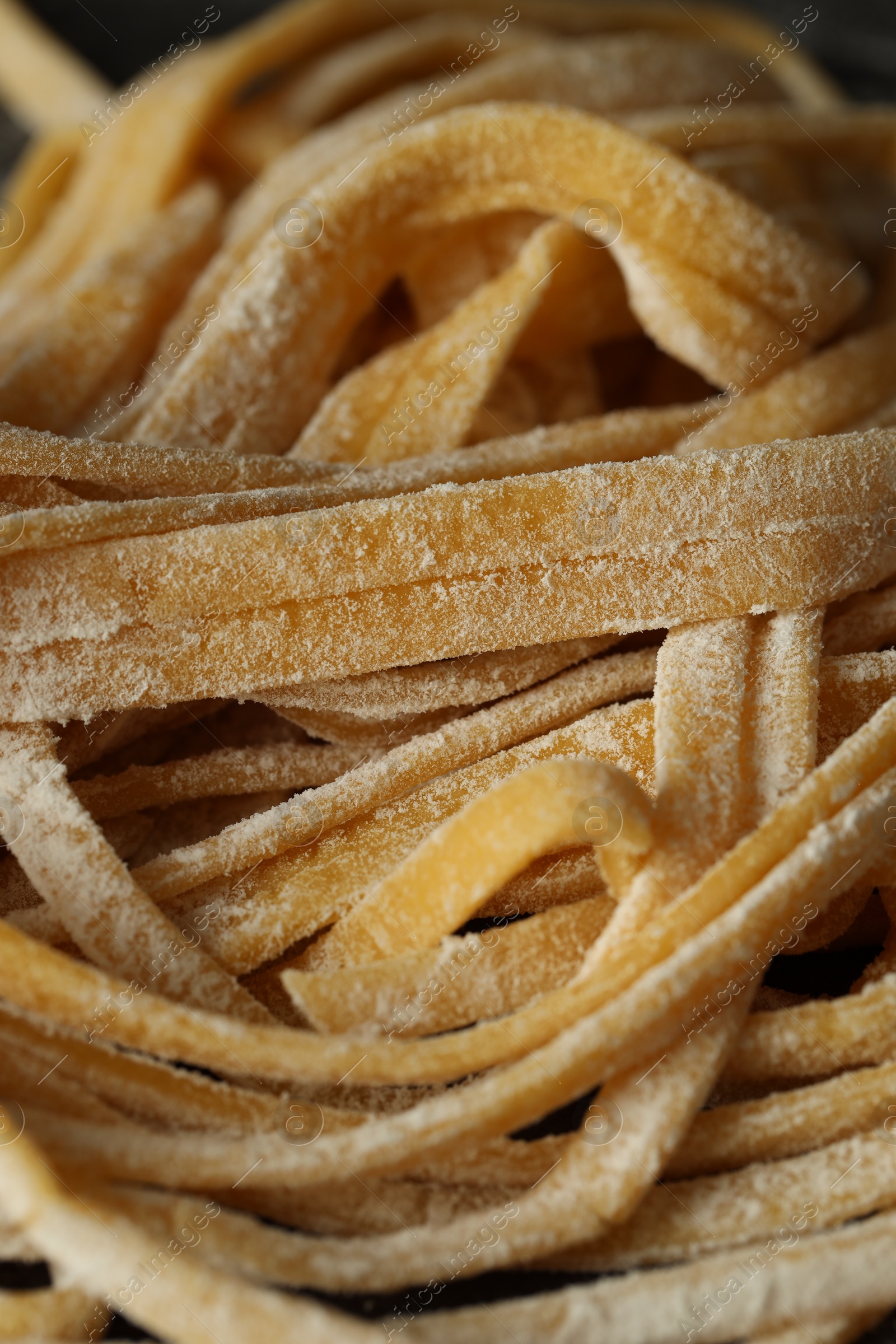 Photo of Uncooked homemade pasta as background, closeup view