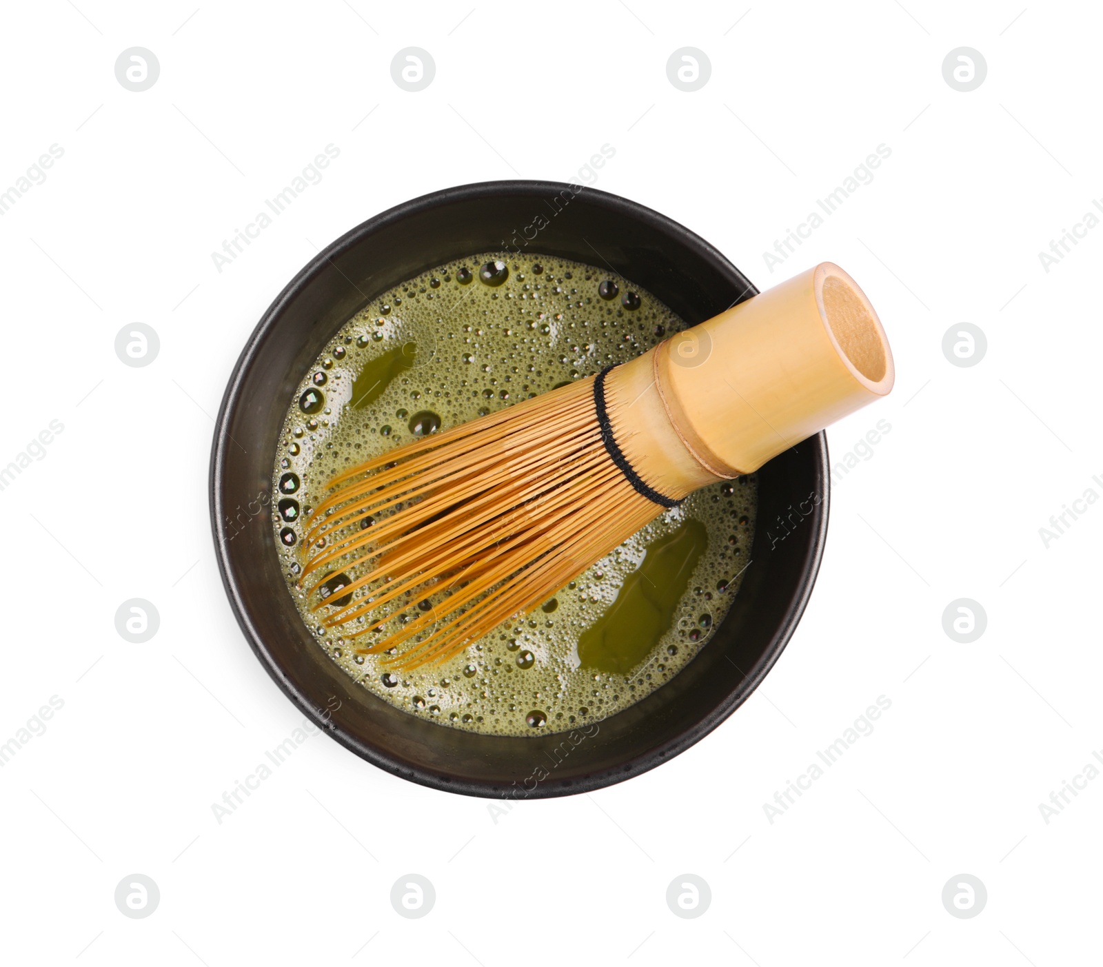 Photo of Cup of matcha tea and bamboo whisk isolated on white, top view