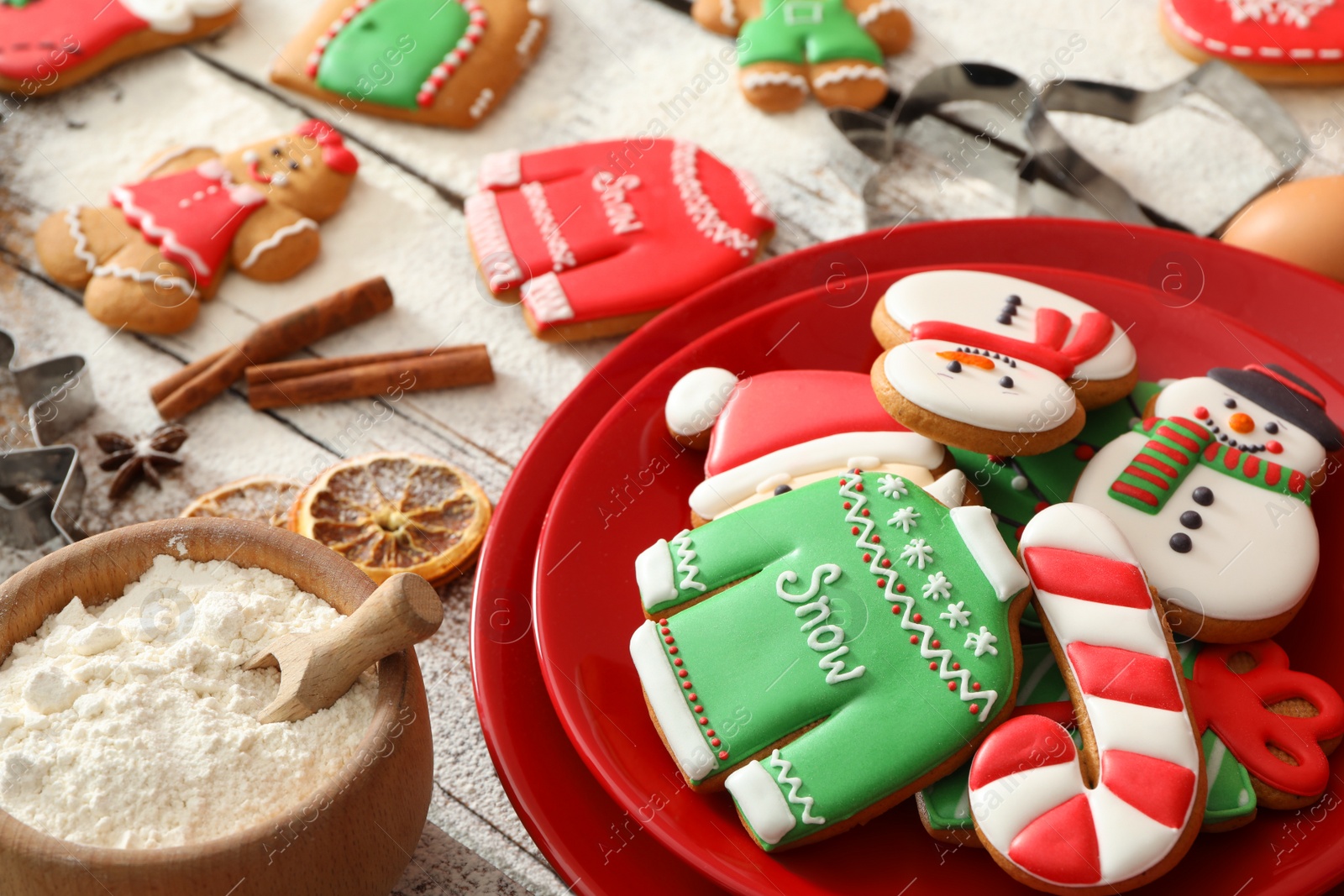 Photo of Delicious homemade Christmas cookies and flour on wooden table