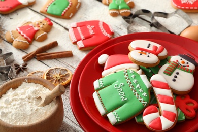 Delicious homemade Christmas cookies and flour on wooden table