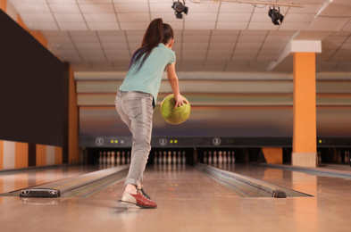 Photo of Little girl throwing ball at bowling club