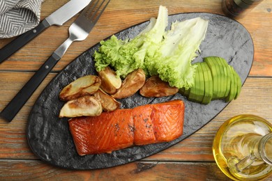 Photo of Tasty cooked salmon and vegetables served on wooden table, flat lay. Healthy meals from air fryer