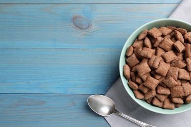 Photo of Delicious chocolate corn pads served on light blue wooden table, flat lay. Space for text