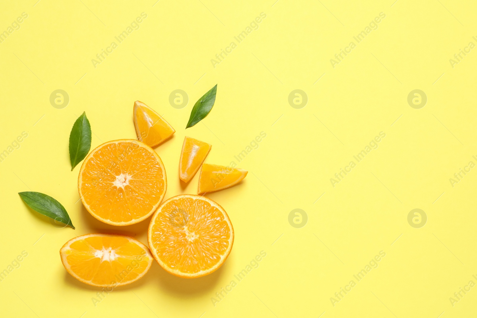 Photo of Flat lay composition with ripe oranges and space for text on color background