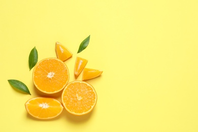 Photo of Flat lay composition with ripe oranges and space for text on color background