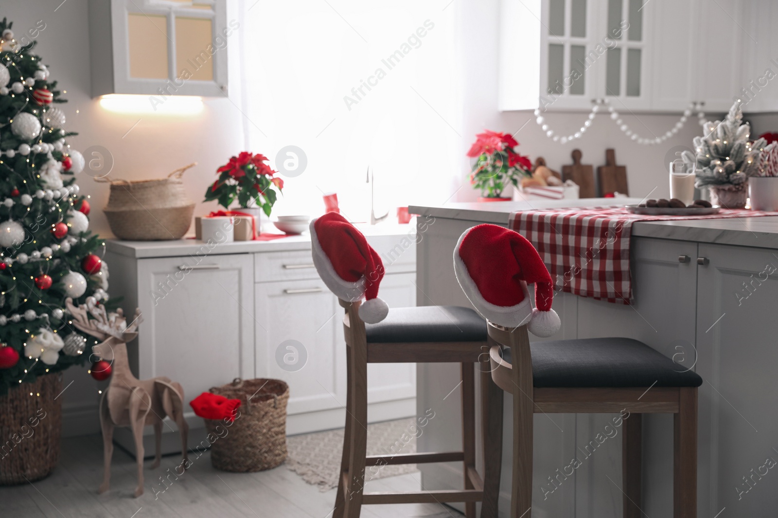 Photo of Beautiful kitchen interior with Christmas tree and festive decor