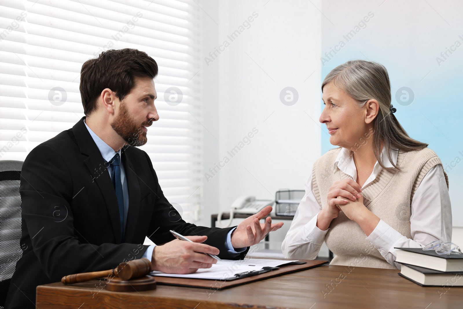 Photo of Senior woman having meeting with lawyer in office