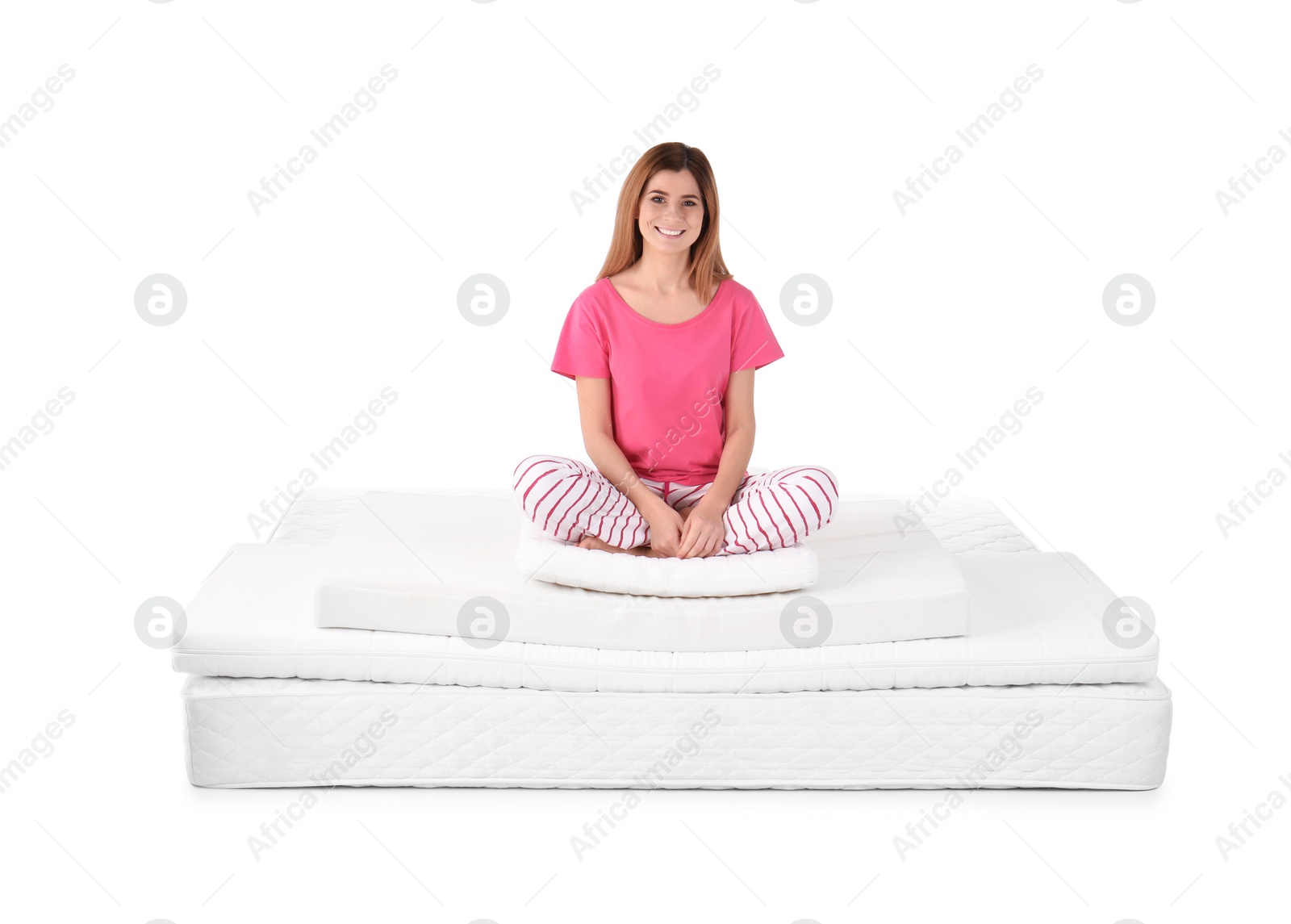 Photo of Woman sitting on mattress pile against white background