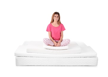 Photo of Woman sitting on mattress pile against white background