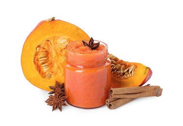 Jar of pumpkin jam, star anise, fresh pumpkin and cinnamon on white background