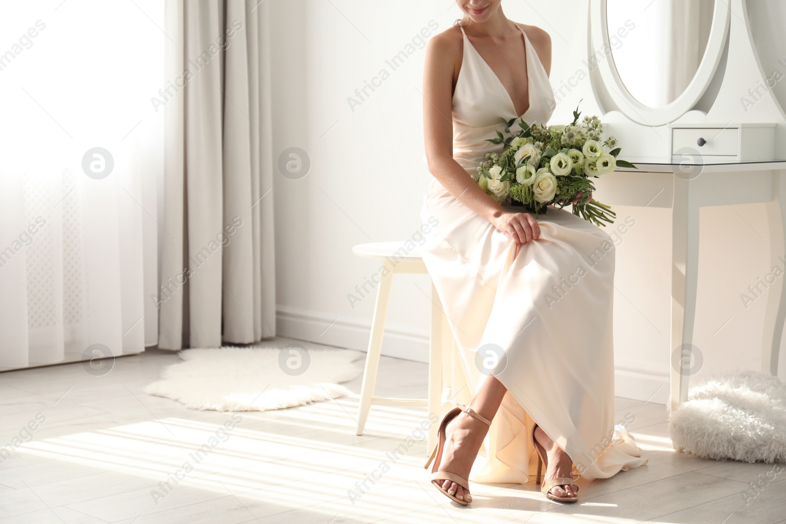 Photo of Young bride in wedding dress with beautiful bouquet indoors, closeup. Space for text