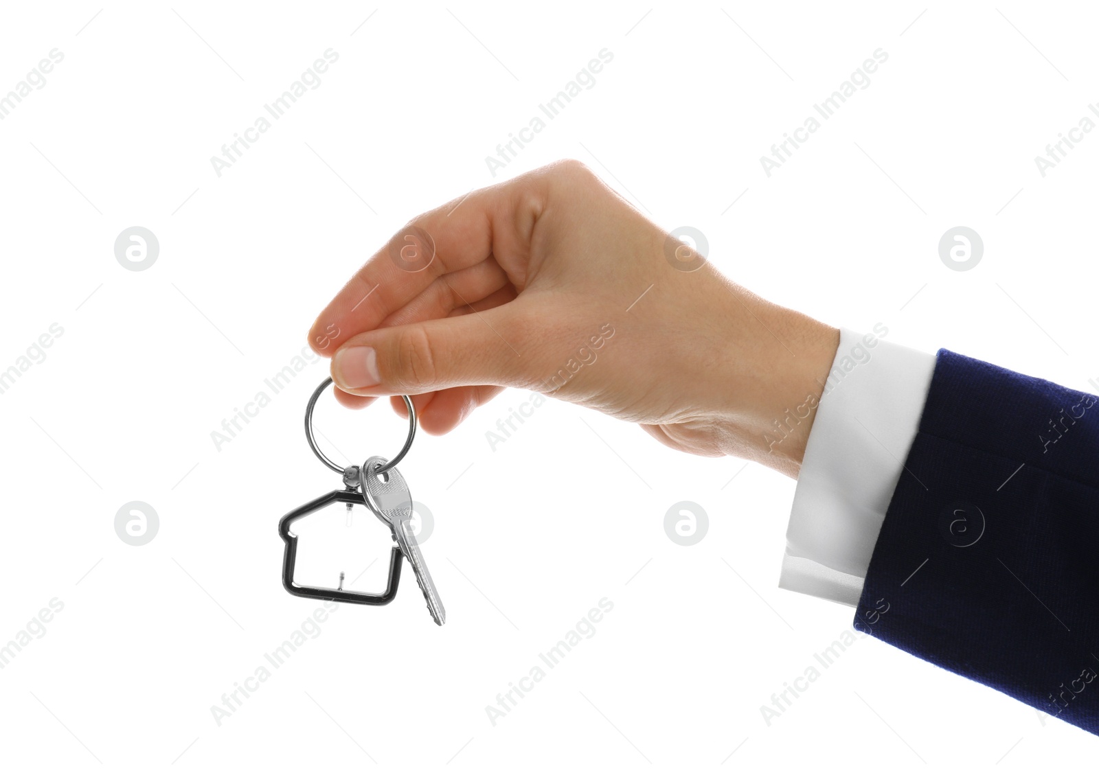 Photo of Real estate agent holding house key with trinket on white background, closeup