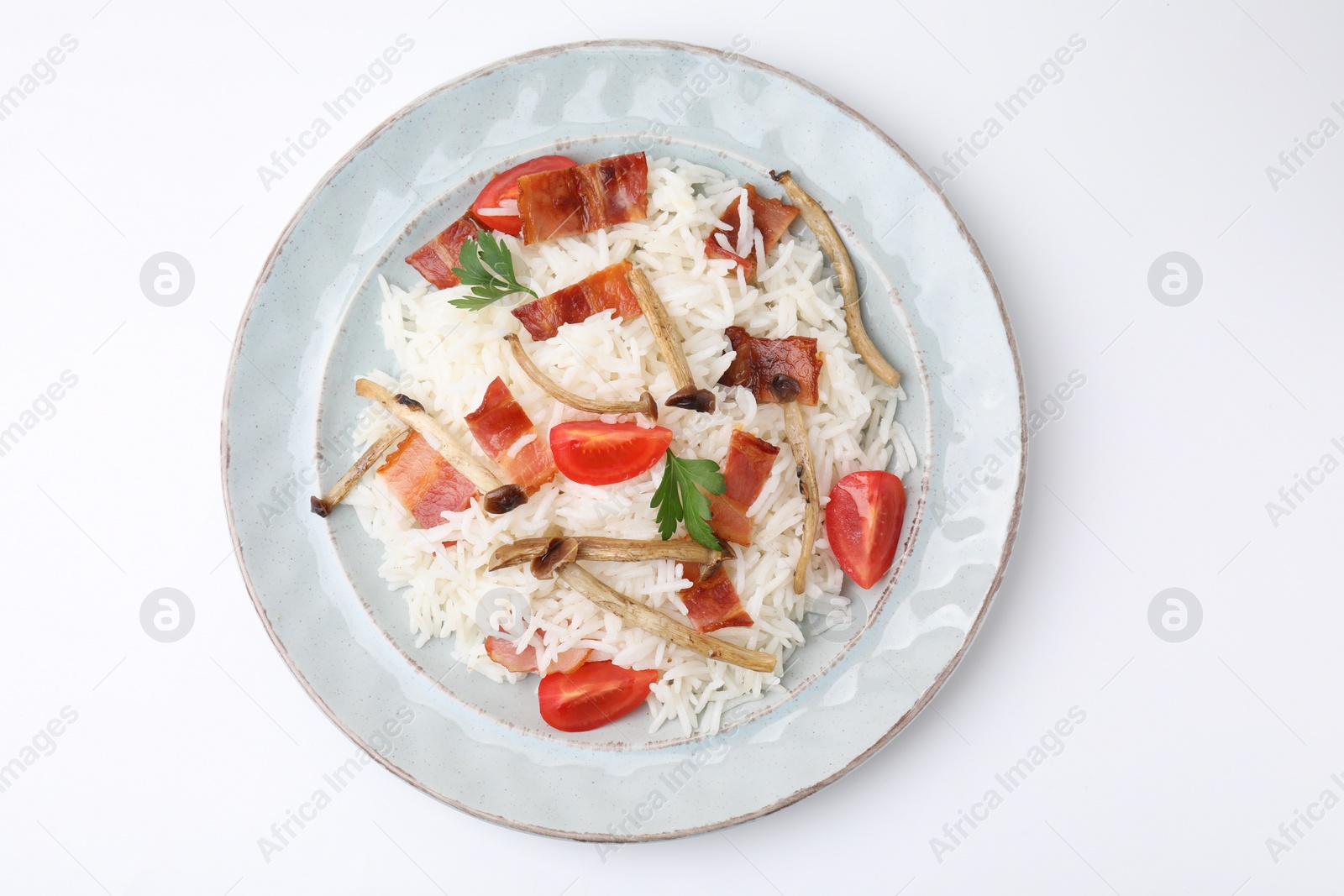 Photo of Delicious rice with bacon, mushrooms and tomatoes isolated on white, top view