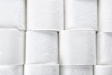 Photo of Many rolls of toilet paper as background. Personal hygiene