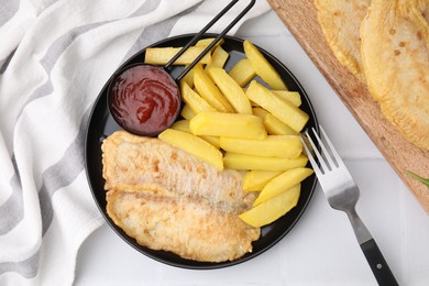 Photo of Delicious fish and chips served on white table, flat lay