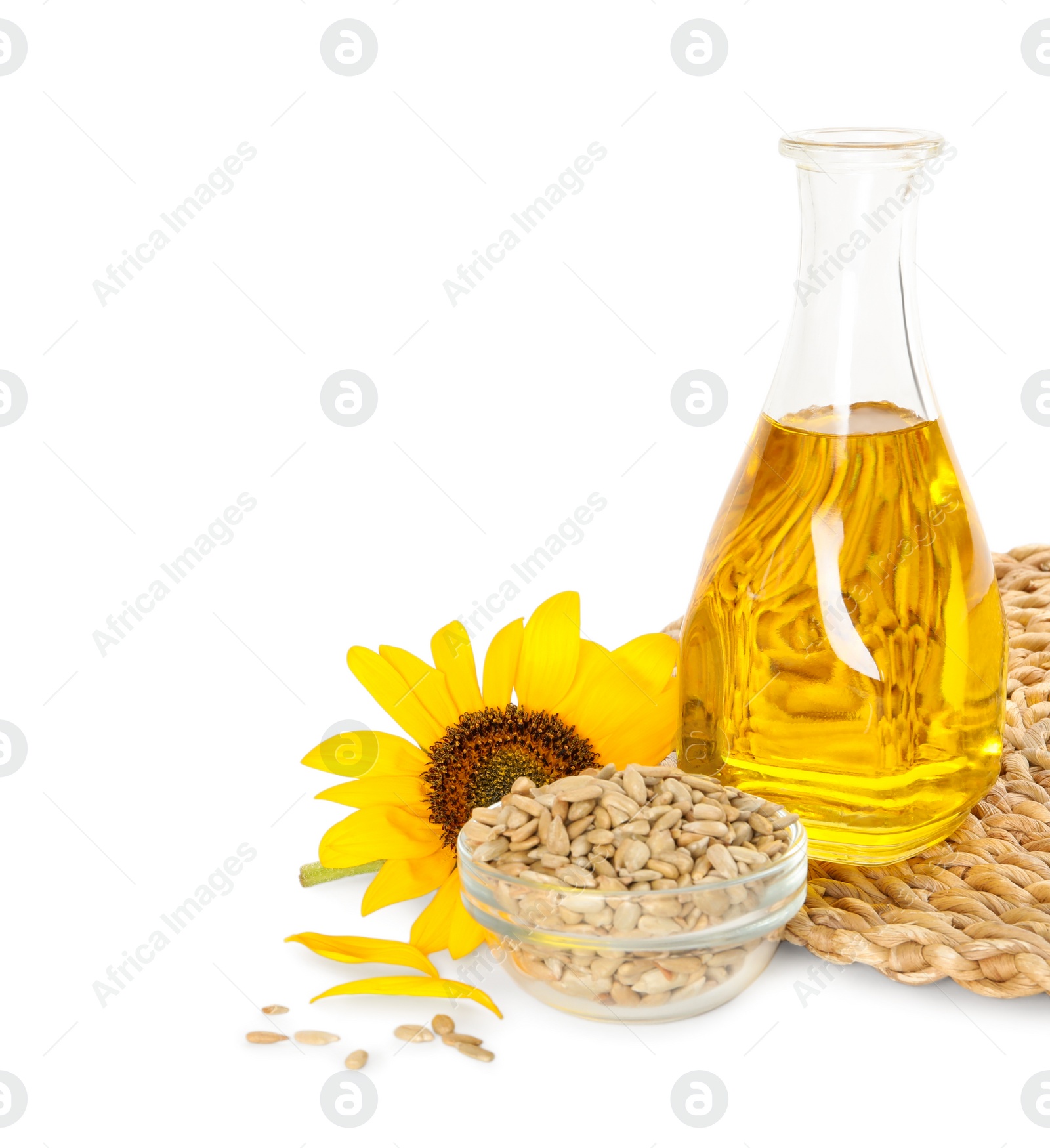 Photo of Sunflower, bottle of oil and seeds on white background