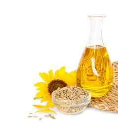 Photo of Sunflower, bottle of oil and seeds on white background