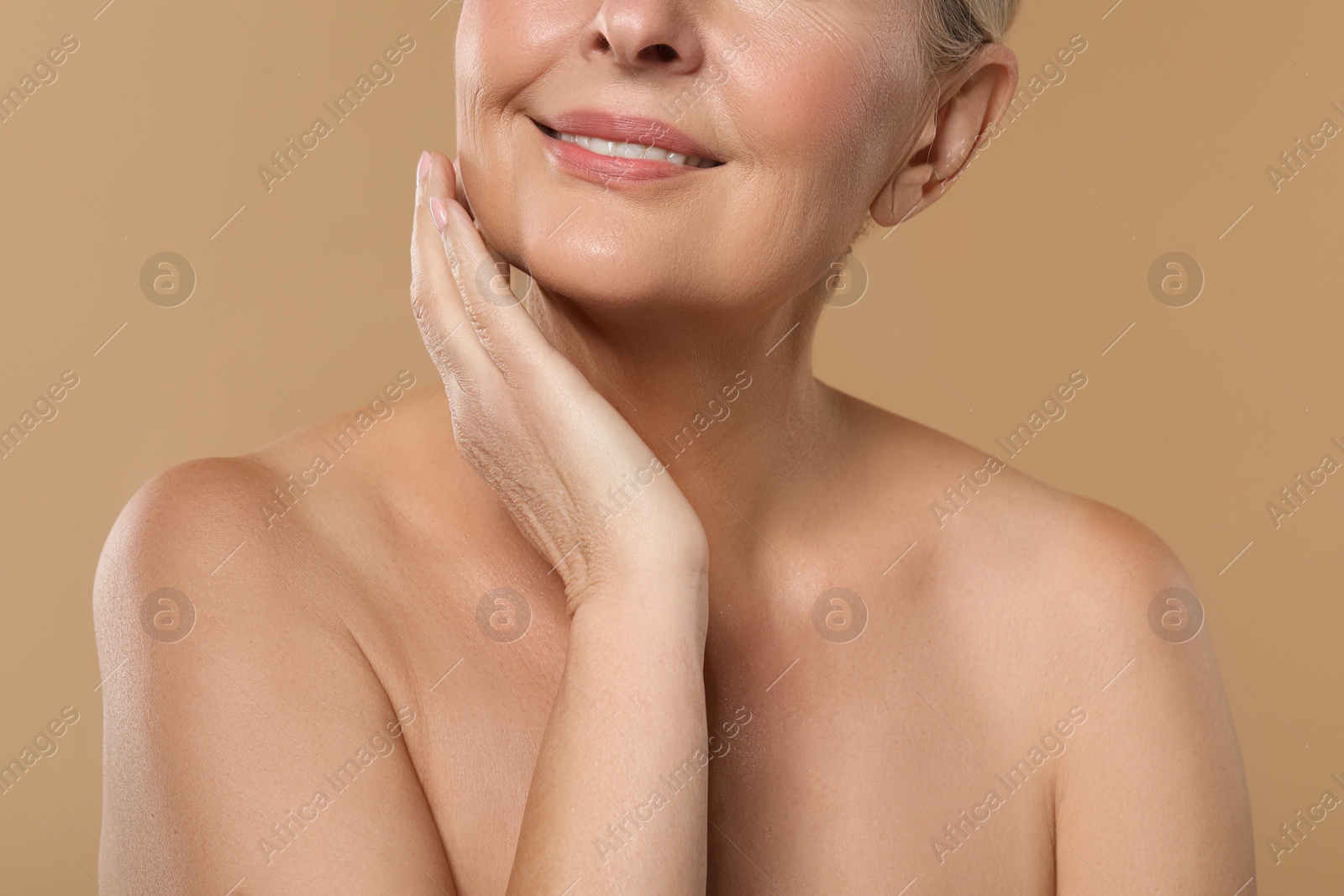 Photo of Woman with healthy skin on beige background, closeup