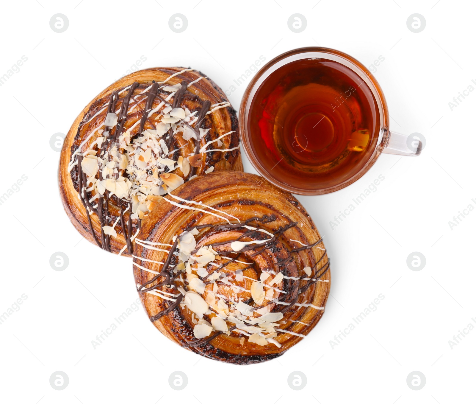 Photo of Delicious rolls with toppings, almond and cup of tea isolated on white, top view. Sweet buns