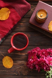Photo of Autumn flat lay composition with beautiful chrysanthemum flowers and cup of tea on wooden table