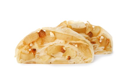 Photo of Pieces of delicious apple strudel with almonds on white background