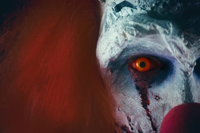 Photo of Terrifying clown, closeup view. Halloween party costume
