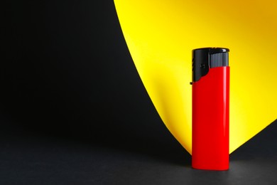 Stylish small pocket lighter on color background, space for text