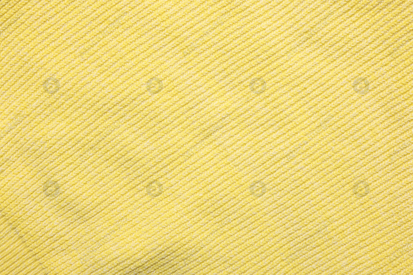 Photo of Texture of soft yellow fabric as background, top view