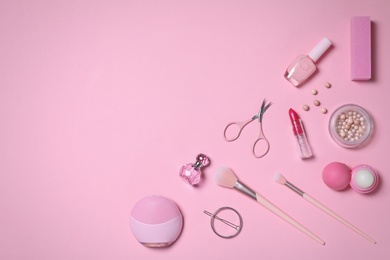 Flat lay composition with personal care products on pink background. Space for text