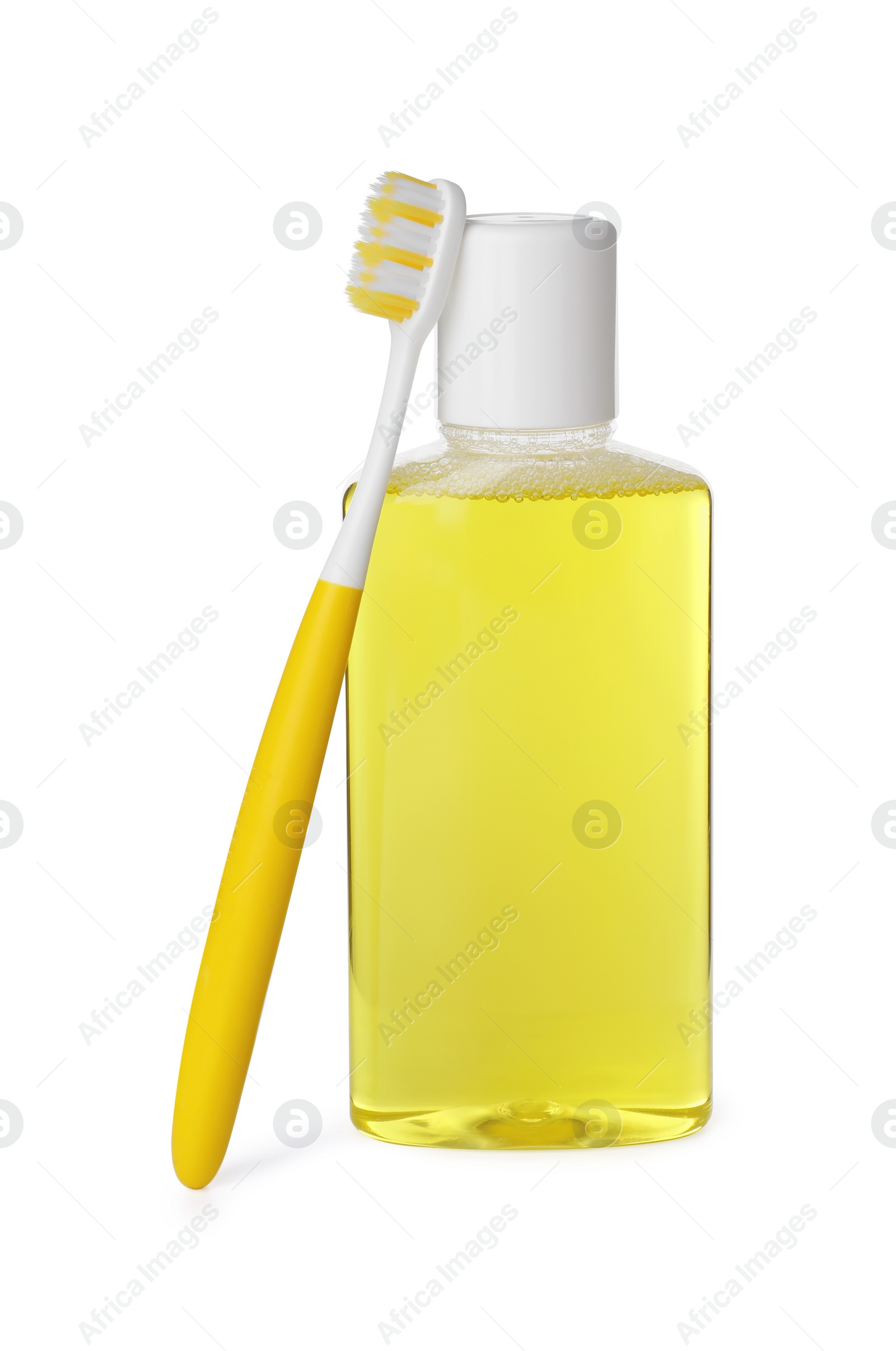 Photo of Bottle of mouthwash and toothbrush isolated on white