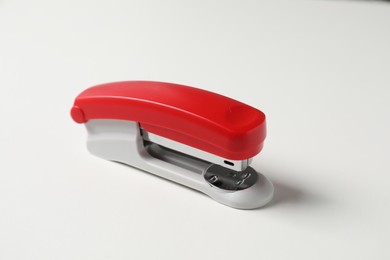 Photo of One stapler on white table. Office stationery