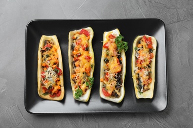 Photo of Delicious stuffed zucchini on grey table, top view