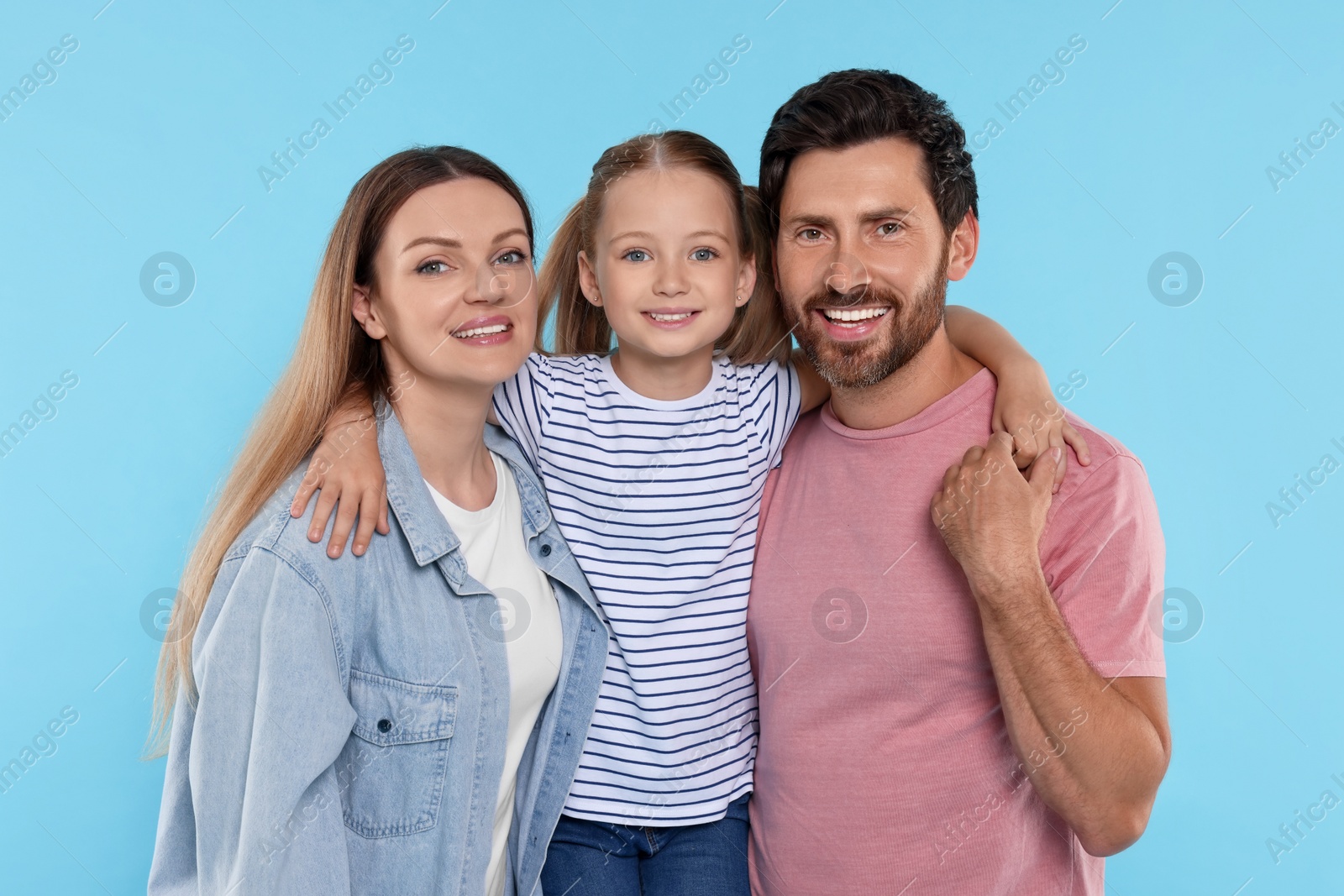 Photo of Happy family together on light blue background