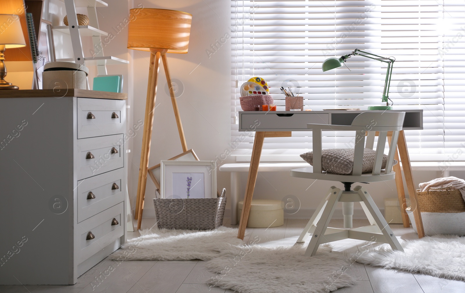 Photo of Stylish room interior with comfortable workplace near window