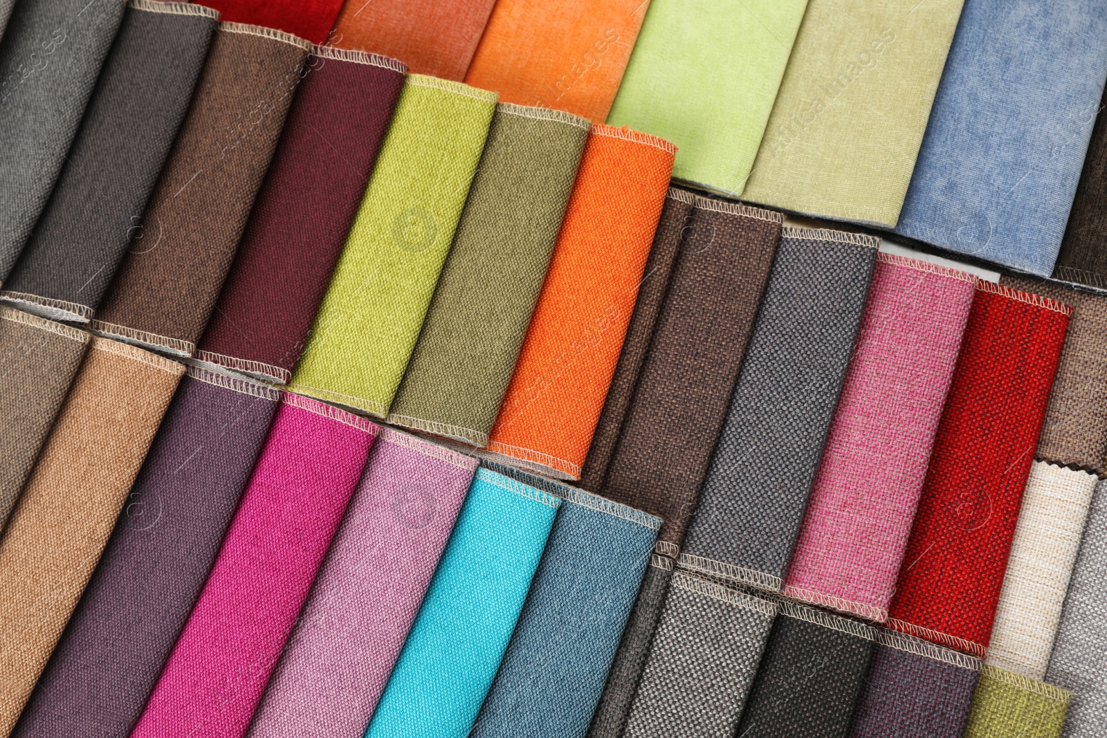 Photo of Fabric samples of different colors as background, top view