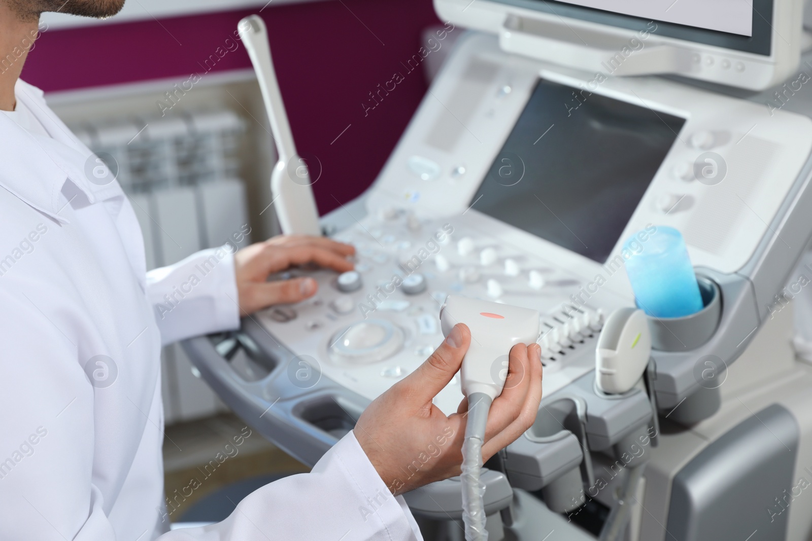 Photo of Sonographer using modern ultrasound machine in clinic, closeup