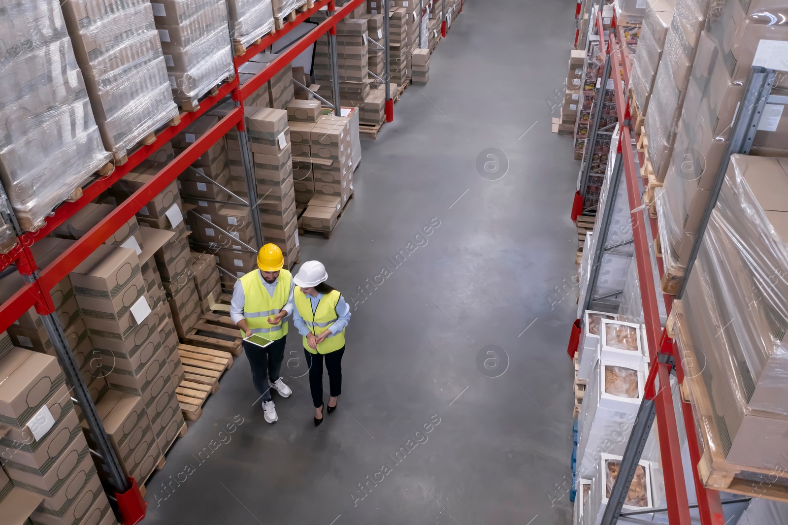 Image of Manager and worker at warehouse, above view. Logistics center