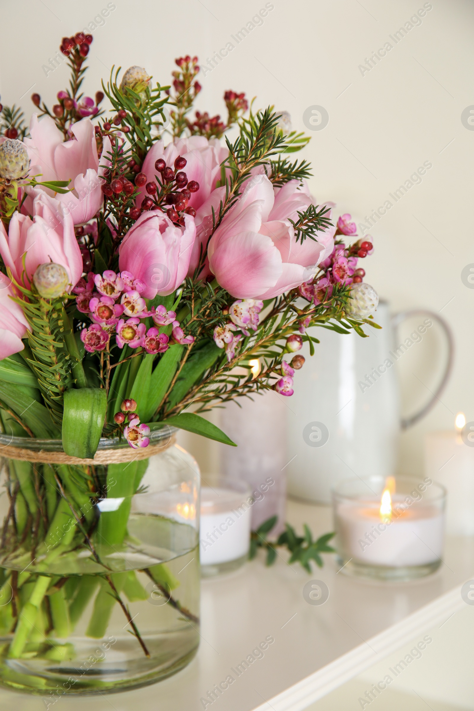 Photo of Beautiful bouquet with spring pink tulips on shelf