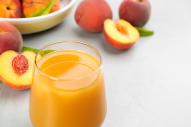 Photo of Natural freshly made peach juice on light table, closeup