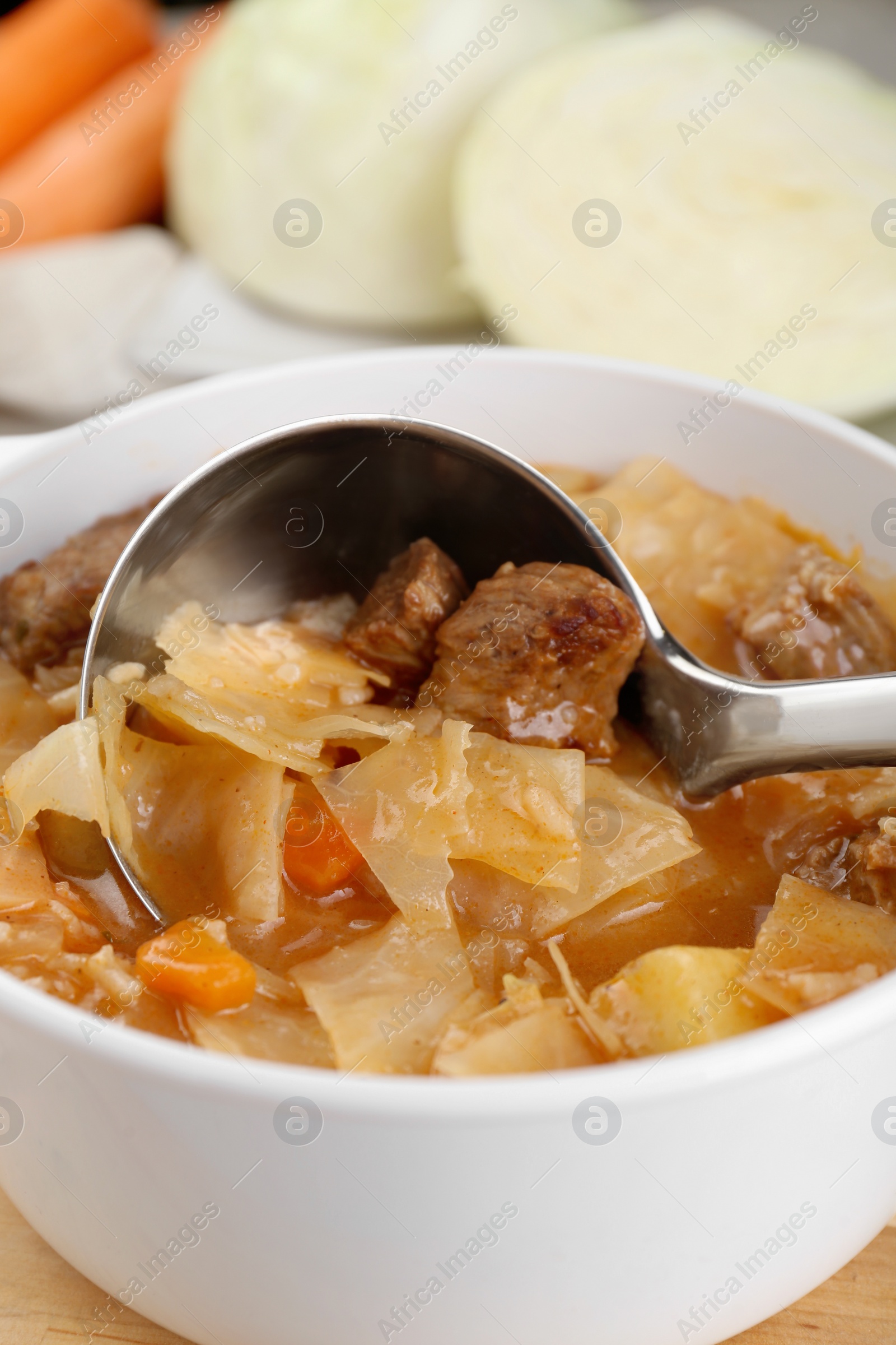 Photo of Tasty cabbage soup with meat and carrot, closeup