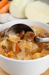 Photo of Tasty cabbage soup with meat and carrot, closeup