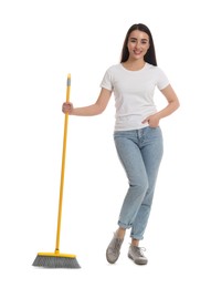 Beautiful young woman with broom on white background